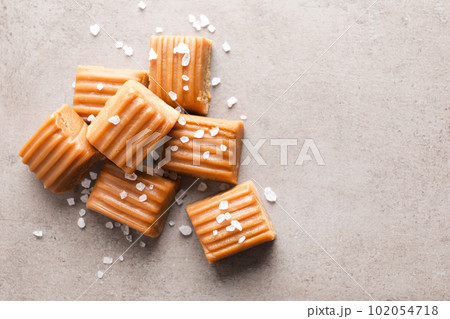 Salted caramel on light grey table, flat lay. Space for text Salted caramel on light grey table, flat lay. Space for text 102054718