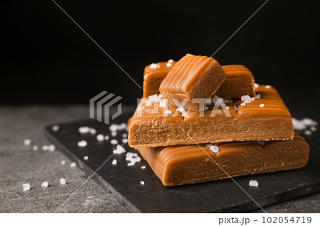 Salted caramel on light grey table, closeup view 102054719