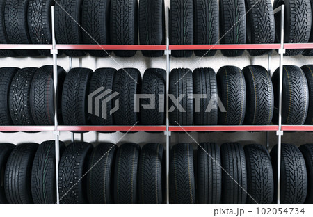 Car tires on rack in auto store Car tires on rack in auto store 102054734