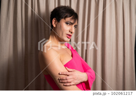 Homosexual in a pink female dress. A man in make-up. Homosexual in a pink female dress. A man in make-up. 102061217