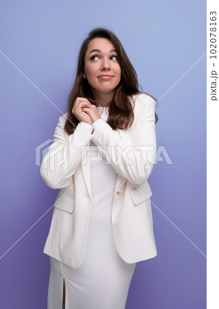 portrait of a well-groomed caucasian brunette woman in a white dress portrait of a well-groomed caucasian brunette woman in a white dress 102078163