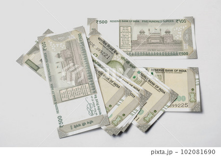 500 hundred rupees Indian money isolated on white background. Pile of Indian money five hundred rupee currency banknotes. 102081690