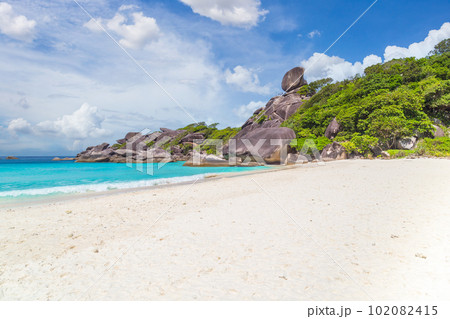 sandy beach with wave crashing on sandy shore at Similan Islands Thailand 102082415