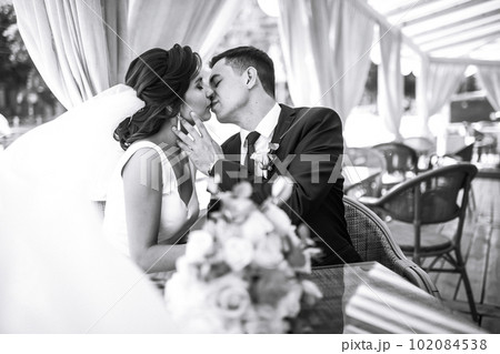 Black and white photo of cheerful emotional newlyweds who enjoy each other. Romantic moment. Together. 102084538