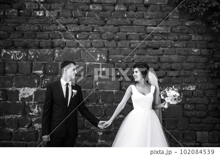 Black and white photo of cheerful emotional newlyweds who enjoy each other. Romantic moment. Together. Black and white photo of cheerful emotional newlyweds who enjoy each other. Romantic moment. Together. 102084539