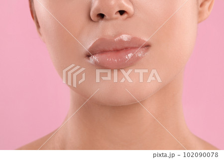 Young woman with beautiful full lips on pink background, closeup Young woman with beautiful full lips on pink background, closeup 102090078