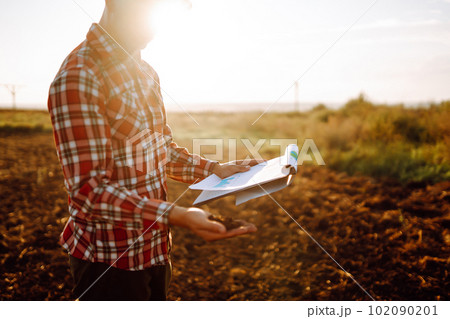 Hand of expert farmer collect soil and checking soil health before growth a seed of vegetable. 102090201
