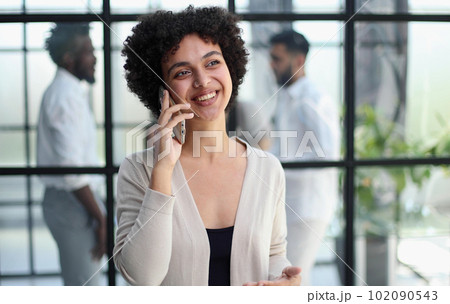 Businesswoman with phone in modern office 102090543