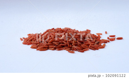 A handful of brown rice on a white isolated background. A handful of brown rice on a white isolated background. 102091122