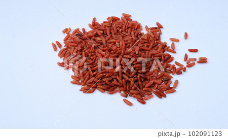 A handful of brown rice on a white isolated background. A handful of brown rice on a white isolated background. 102091123