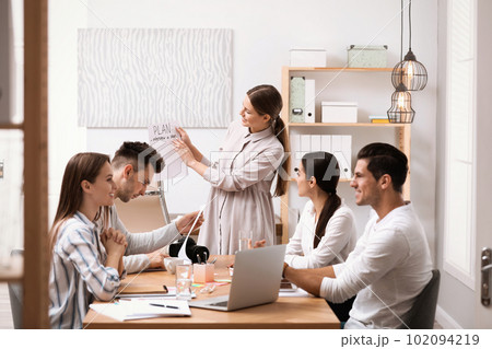 Team of professional journalists working in office 102094219