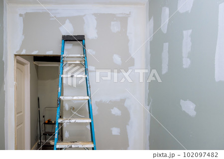 In this newly built house that has been plastered with drywall is now ready for painting 102097482