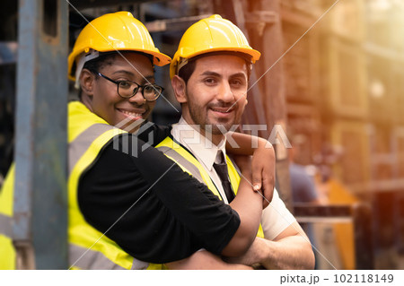 Happy industry worker friends working together mix race gender. black woman with hispanic latin man. 102118149