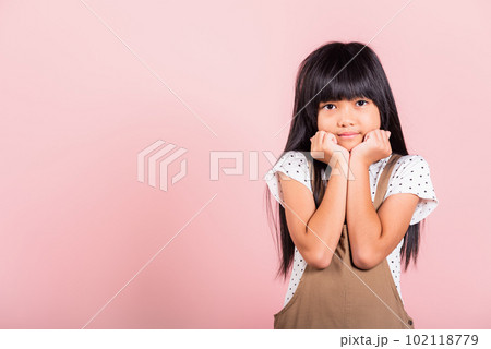 Asian little kid 10 years old hands touch chin thinking dream at studio shot isolated on pink background, Portrait of Happy child girl positive smiling rejoices good day with lover 102118779
