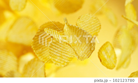 Potatoes chips flying up in the air. 102123780