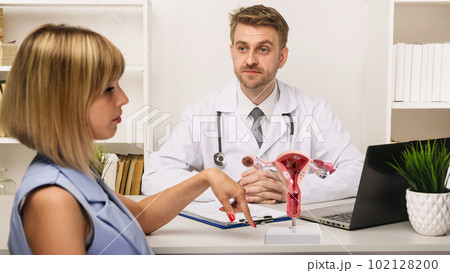 Young woman on a consultation with a male surgeon or therapist in his office. Young woman on a consultation with a male surgeon or therapist in his office. 102128200