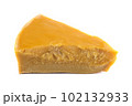 A piece of natural beeswax on a white background. 102132933