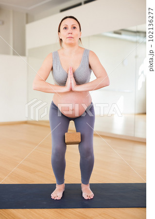 Woman does yoga in the gym.pregnant woman does yoga in the gym 102136277