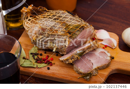 Boiled pork on chopping board with mixed peppercorns, bay leaf, cinnamon Boiled pork on chopping board with mixed peppercorns, bay leaf, cinnamon 102137446