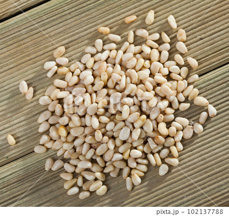 Picture of wooden desk with raw pine nut, nobody 102137788