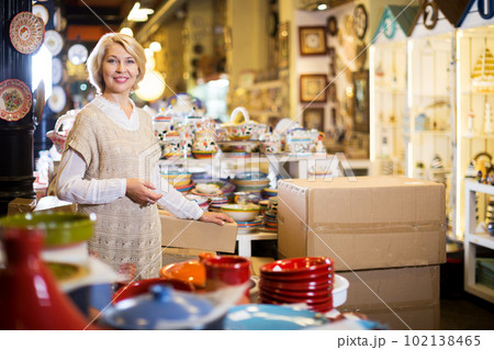 Woman posing with ceramic tableware 102138465