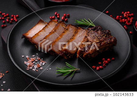 Delicious juicy pork steak on the bone with spices and herbs 102143633
