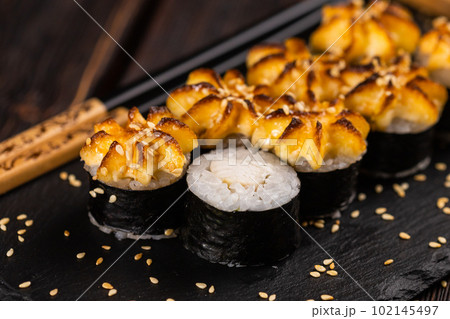 Japanese hot maki roll sushi with shrimp close up - asian food concept Japanese hot maki roll sushi with shrimp close up - asian food concept 102145497