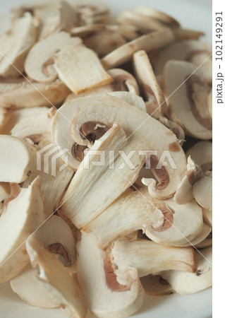 Fresh champignons mushroom in a white bowl on table  102149291