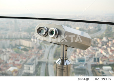 Coin-operated binoculars looking out over city , Coin-operated binoculars looking out over city , 102149415
