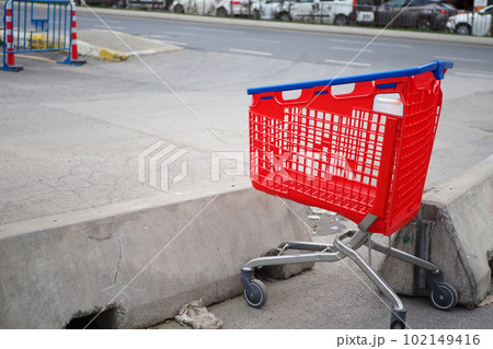 Shopping cart in a empty car park Shopping cart in a empty car park 102149416