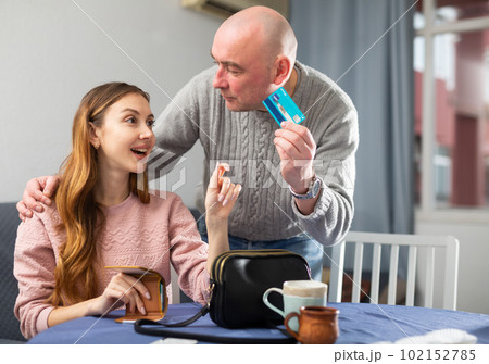 Husband giving plastic card to his wife 102152785