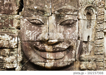 Face carved in stone in Angkor Wat Face carved in stone in Angkor Wat 102157308