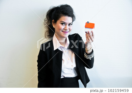 Business woman hold house toy model on white background 102159459