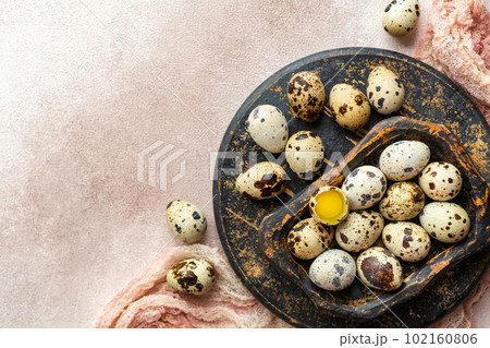 Fresh quail eggs in a wooden plate. Healthy food. View from above. Fresh quail eggs in a wooden plate. Healthy food. View from above. 102160806