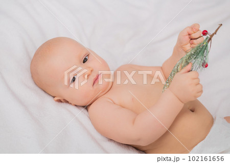 Close-up portrait of baby boy with brown eyes lying in bed. Close-up portrait of baby boy with brown eyes lying in bed. 102161656