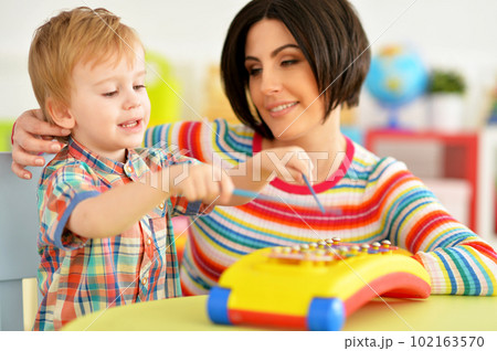 Young mother and cute little son playing 102163570