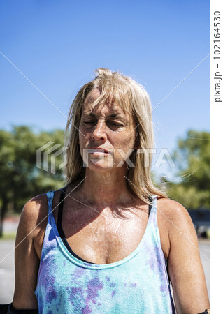Smiling middle age woman portrait with skateboard in sport lifestyle at summer sunny day. Street urban sporty lifestyle concept. Smiling middle age woman portrait with skateboard in sport lifestyle at summer sunny day. Street urban sporty lifestyle concept. 102164530