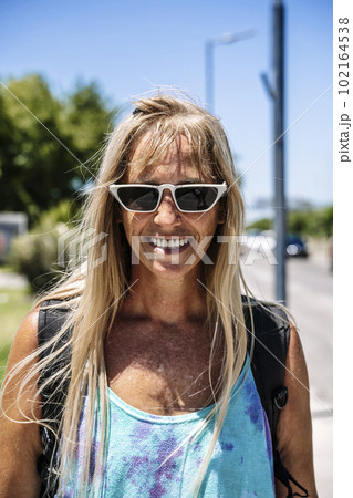 Smiling middle age woman portrait with skateboard in sport lifestyle at summer sunny day. Street urban sporty lifestyle concept. Smiling middle age woman portrait with skateboard in sport lifestyle at summer sunny day. Street urban sporty lifestyle concept. 102164538