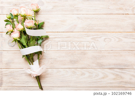 Bouquet of pinkand white roses on colored background. Mother's day, Valentines Day, Birthday celebration concept. Greeting card. Copy space for text, top view Bouquet of pinkand white roses on colored background. Mother's day, Valentines Day, Birthday celebration concept. Greeting card. Copy space for text, top view 102169746