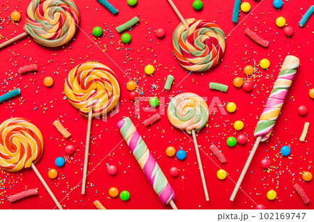 Tasty appetizing Party Accessories Happy Birthday Sweet. Different types of candies on colored background, copy space. Colorful birthday party background Tasty appetizing Party Accessories Happy Birthday Sweet. Different types of candies on colored background, copy space. Colorful birthday party background 102169747