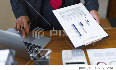 Business analysis concept, Senior businessman reading business chart and typing data on laptop 102171248