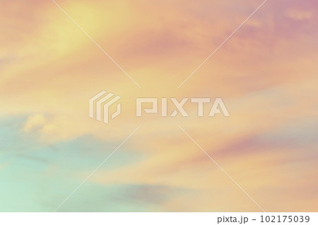 Sky with soft and fluffy pastel orange pink and blue colored clouds. Sunset background. Nature. sunrise. 102175039
