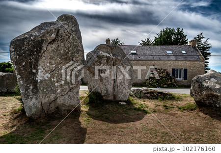 Ancient Stone Field Kerzerho Cruzuno With Neolithic Megaliths And Cottage Near Finistere Village Carnac In Brittany, France Ancient Stone Field Kerzerho Cruzuno With Neolithic Megaliths And Cottage Near Finistere Village Carnac In Brittany, France 102176160