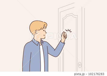 Young man knocks on door when comes to visit friend or company office to get job Young man knocks on door when comes to visit friend or company office to get job 102176283