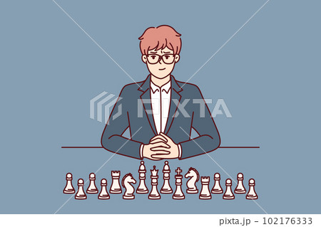 Business man with chess pieces sits at table and looks at screen for concept of strategic planning 102176333