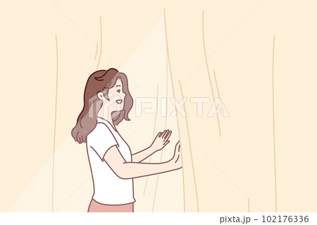 Smiling woman looks out window opening curtains and enjoying rays of summer morning sun Smiling woman looks out window opening curtains and enjoying rays of summer morning sun 102176336