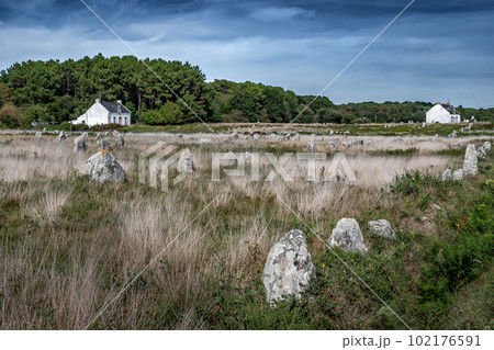 Ancient Stone Field Alignements De Menhir Carnac With Neolithic Megaliths And Old Cottage In Brittany, France 102176591