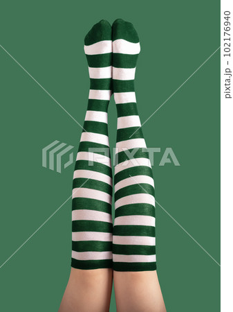 Long sexy female legs stretched high up in striped green and white stockings, tights for St Patrick holiday, 17 March party Long sexy female legs stretched high up in striped green and white stockings, tights for St Patrick holiday, 17 March party 102176940