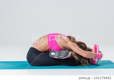 Sporty flexible girl doing stretching exercise 102179882