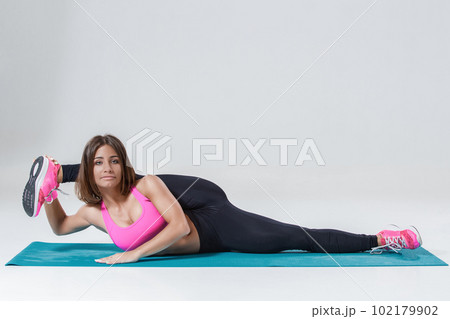 Sporty flexible girl doing stretching exercise Sporty flexible girl doing stretching exercise 102179902